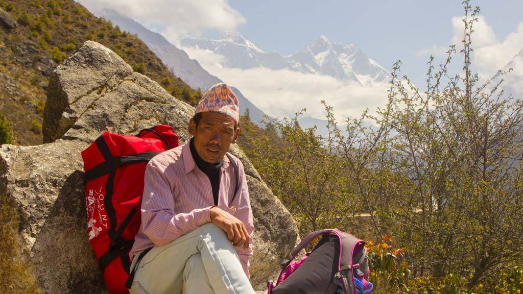 Indra Magar - A porter Guide from Lukla posing with Everest in the backdrop.